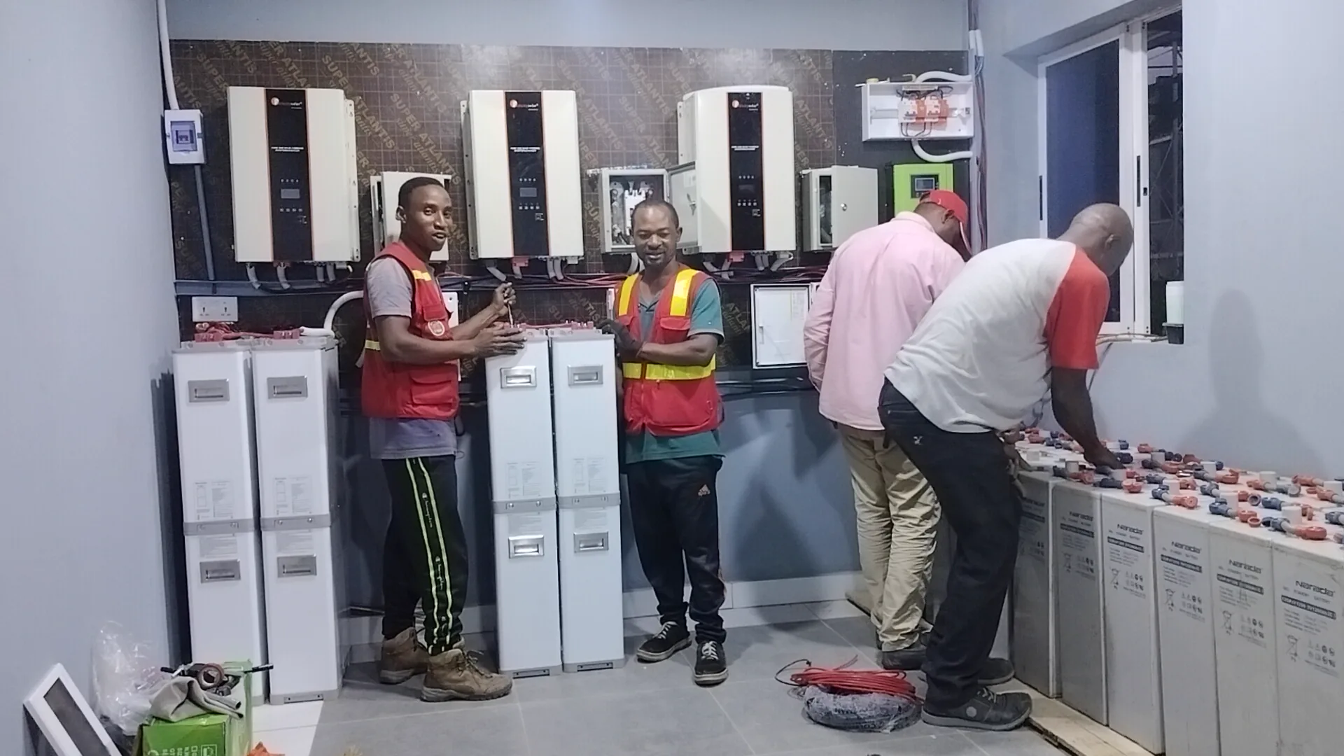 Technician working on battery-installation equipment