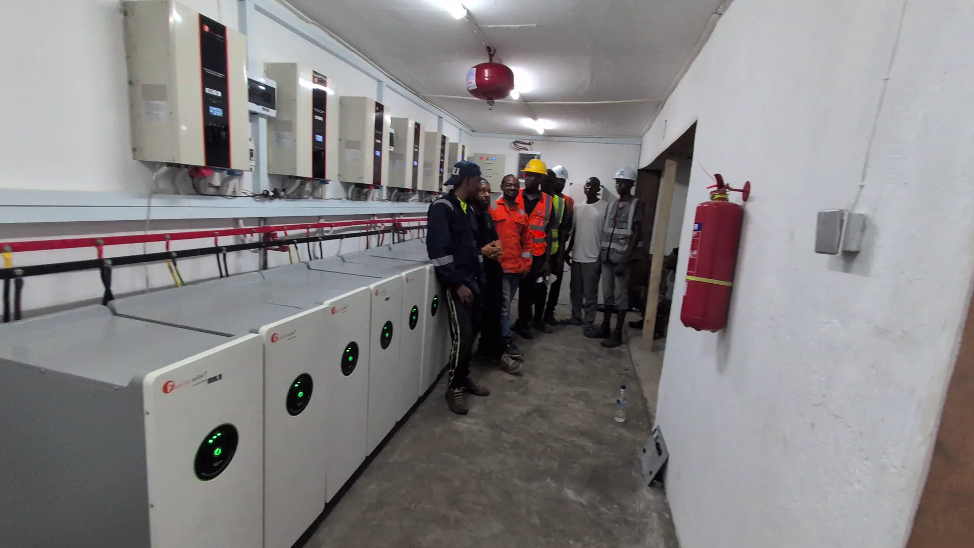Team beside an industrial battery line